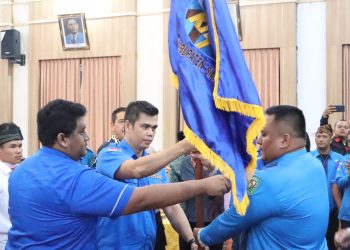 Sekretaris DPD KNPI Sumut Samsul Bahri Purba menyerahkan pataka kepada Ketua KNPI Kabupaten Simalungun Juni Pardomuan Saragih SE pada pelantikan Pengurus DPD Kabupaten Simalungun, Di Balai Harungguan Pamatang Raya, Kantor Bupati Simalungun.( Nawasenanews/ Susan)