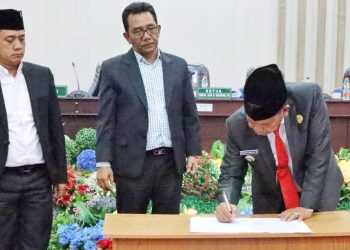 Disaksikan Ketua DPRD Kabupaten Simalungun, Bupati Simalungun menandatangani berita acara persetujuan bersama antara Pemerintah dan DPRD Kabupaten Simalungun oleh Bupati Simalungun dan Ketua DPRD serta wakil-wakil ketua. ( Nawasenanews/Ist)